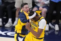 Indiana Pacers' Myles Turner celebrates with T.J. McConnell during the second half of Game 4 of the first round NBA playoff basketball series against the Milwaukee Bucks, Sunday, April 28, 2024, in Indianapolis. (AP Photo/Michael Conroy)