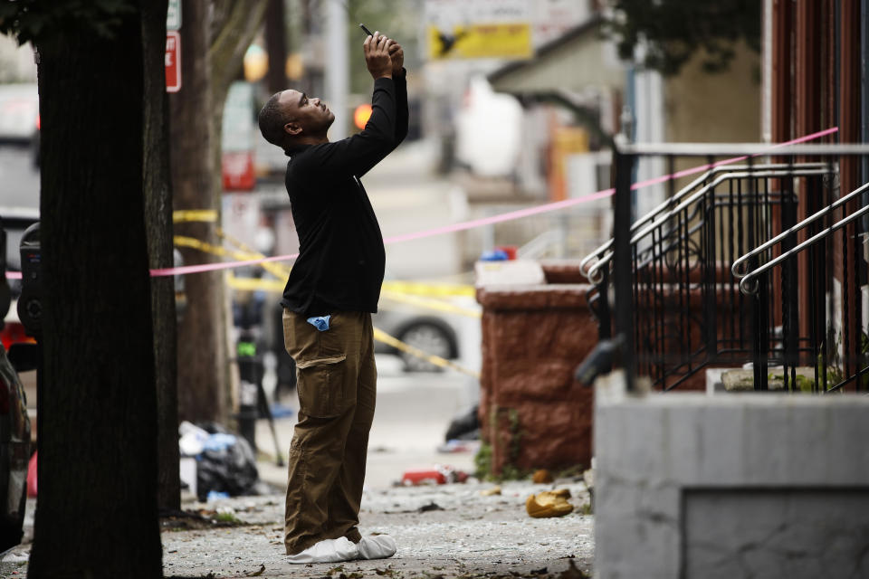 An investigator photographs the scene of Saturday's fatal car explosion in Allentown, Pa., Monday, Oct. 1, 2018. (AP Photo/Matt Rourke)