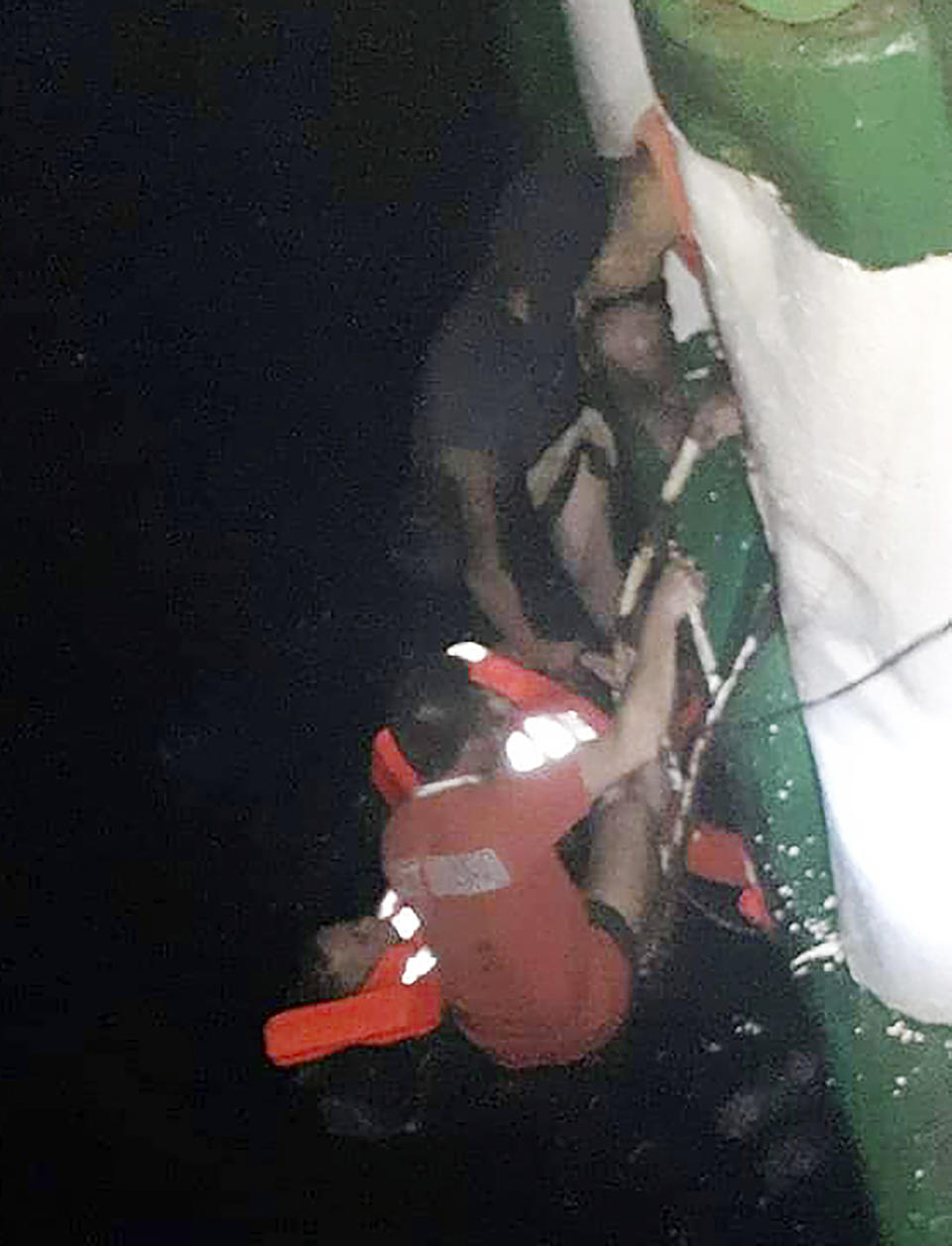 In this photo provided by Philippine Coast Guard in Manila, passengers are rescued by Philippine Coast Guard rescuers and crew of responding vessels from the M/V Lite Ferry 16 which caught fire before dawn Wednesday, Aug. 28, 2019 off Dapitan city in Zamboanga del Norte province in southern Philippines.(Philippine Coast Guard via AP)