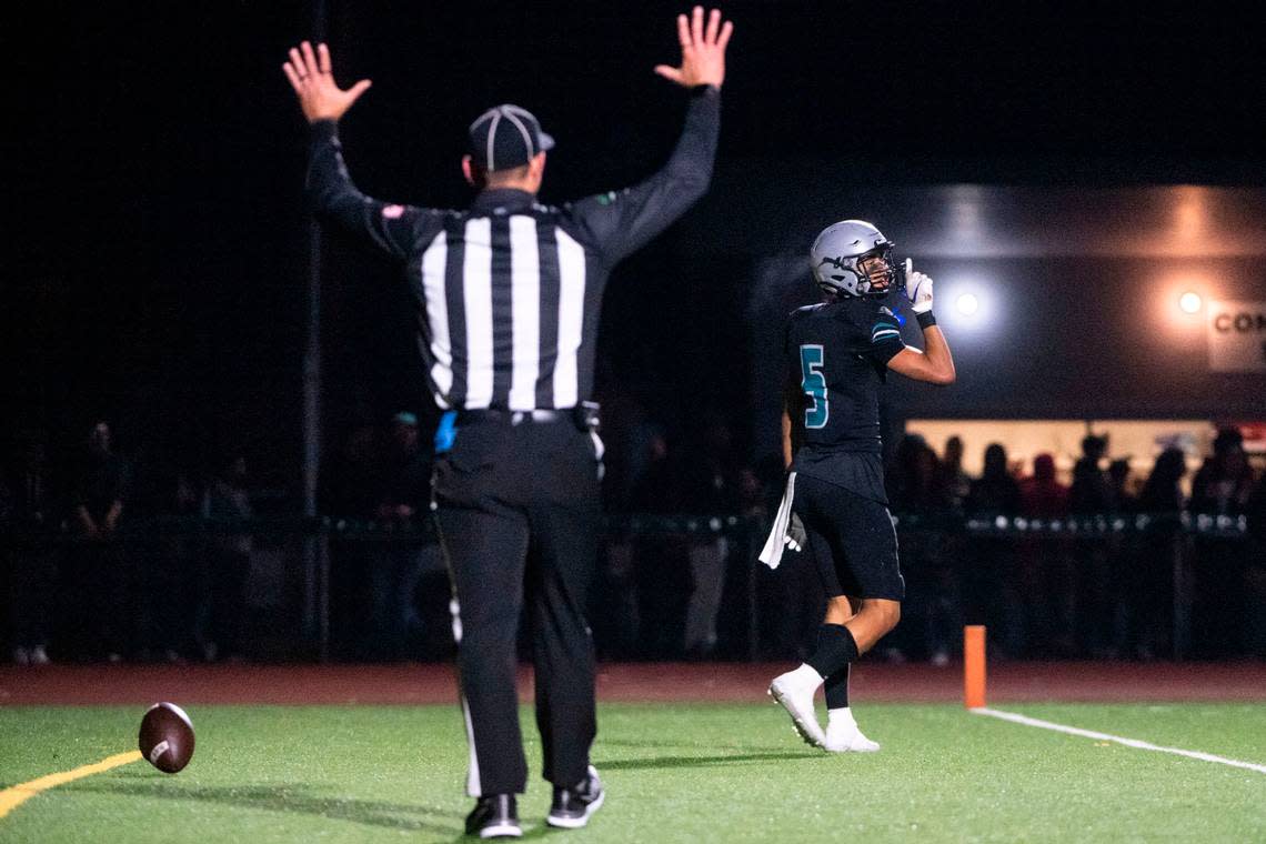 After catching a long touchdown pass from quarterback Dempsy James, Spanaway Lake receiver Zion Jones motions toward the Lincoln sideline during the second quarter of a 3A PCL game on Friday, Oct. 28, 2022, at Art Crate Field in Spanaway, Wash.