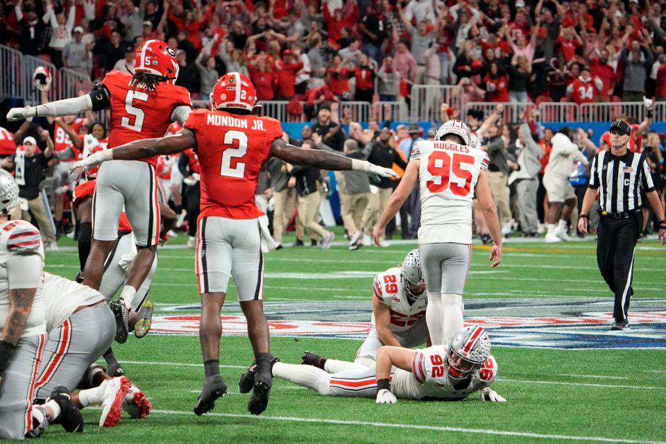 Dec 31, 2022; Atlanta, Georgia, USA; Georgia Bulldogs players celebrate as Ohio State Buckeyes place kicker <a class="link " href="https://sports.yahoo.com/ncaaf/players/404153" data-i13n="sec:content-canvas;subsec:anchor_text;elm:context_link" data-ylk="slk:Noah;sec:content-canvas;subsec:anchor_text;elm:context_link;itc:0">Noah</a> Ruggles (95) misses a 50 yard field goal in the final seconds of the second half of the Peach Bowl in the College Football Playoff semifinal at Mercedes-Benz Stadium. Mandatory Credit: Adam Cairns-The Columbus Dispatch