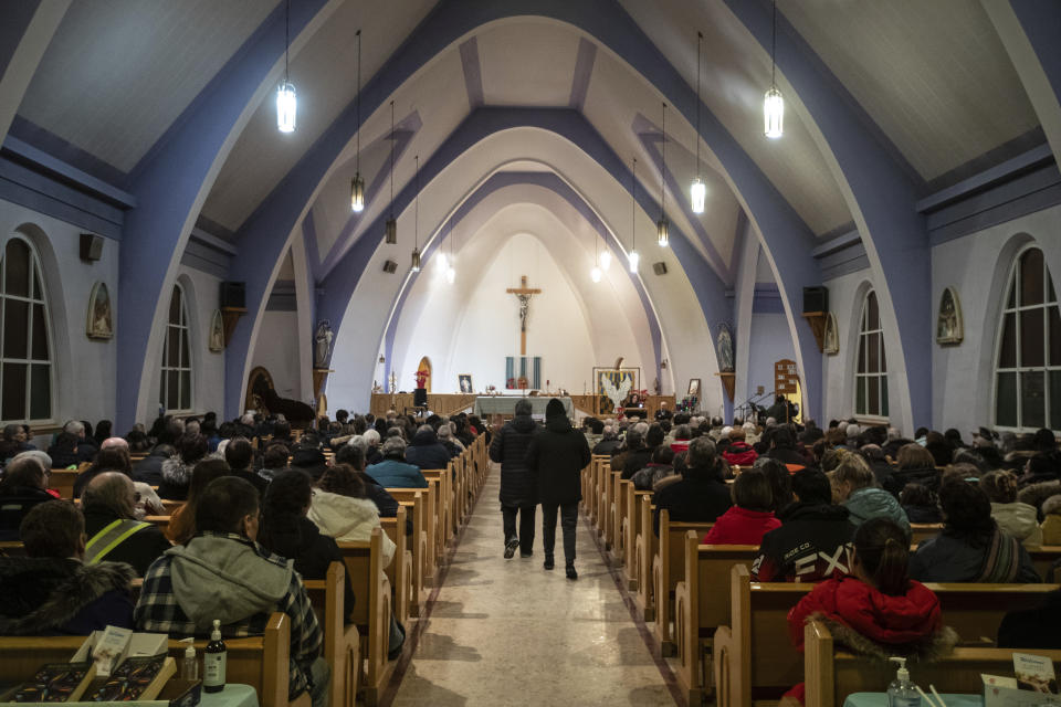 Community members gather and hold a vigil for the six people killed in a plane crash, in Fort Smith, Northwest Territories, on Wednesday, Jan. 24, 2024. (Jason Franson/The Canadian Press via AP)