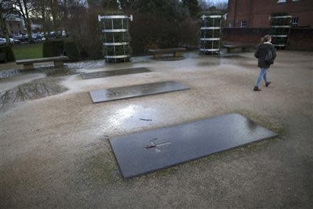 Three headstones mark the spot of the former Hyde Abbey, where a pelvic bone that could potentially belong to either King Alfred the Great or his son Edward the Elder was found, in Winchester, southern England January 17, 2014. REUTERS/Kieran Doherty