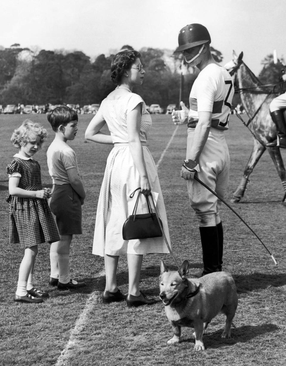 <p>Four years after becoming monarch, Queen Elizabeth supported Prince Philip at a polo game in Windsor Park — and made it a family outing, bringing along a young Prince Charles and Princess Anne...along with one of the family's corgis!</p>