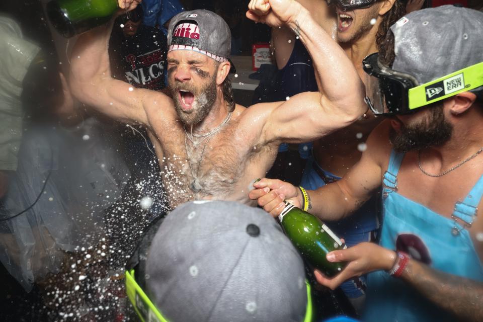 Bryce Harper celebrates in the Phillies' clubhouse after clinching the NLDS.