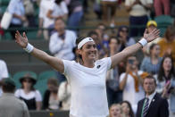 Tunisia's Ons Jabeur celebrates defeating Belgium's Elise Mertens during a fourth round women's singles match on day seven of the Wimbledon tennis championships in London, Sunday, July 3, 2022. (AP Photo/Alberto Pezzali)