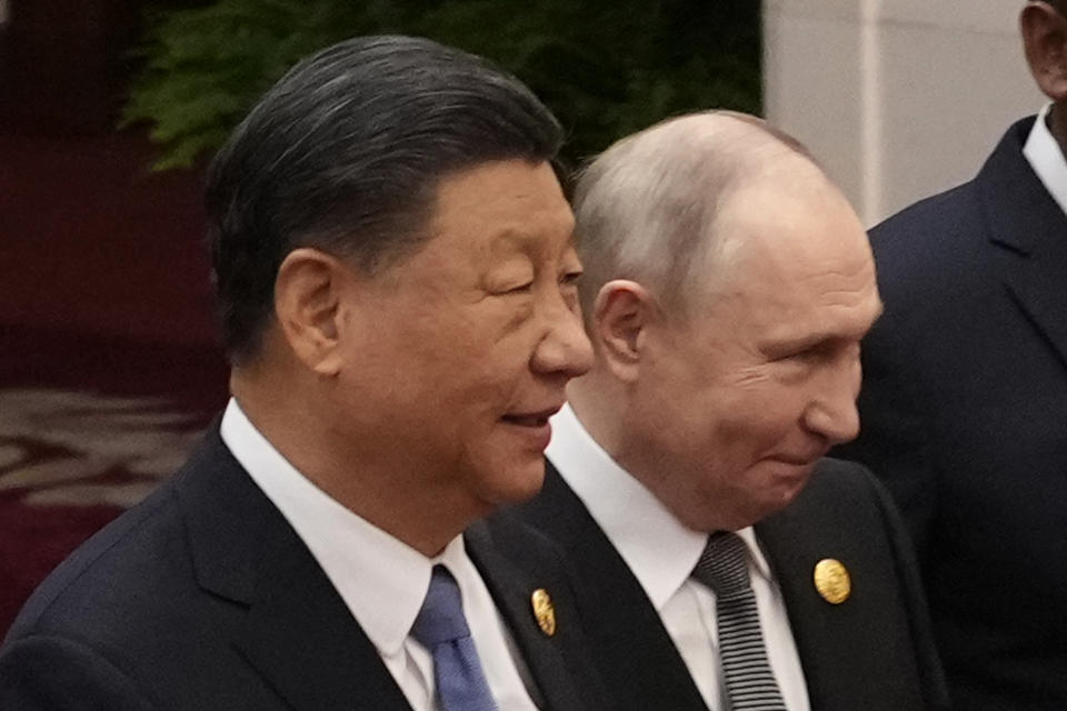 Chinese President Xi Jinping, left, and Russian President Vladimir Putin head to a group photo session at the Belt and Road Forum in Beijing Wednesday, Oct. 18, 2023. (Suo Takekuma/Pool Photo via AP)