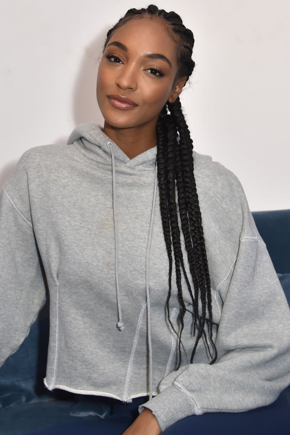 <p>Model Jourdan Dunn wears her long hair braided tightly at the scalp and lets the length fall down to her waist. </p>