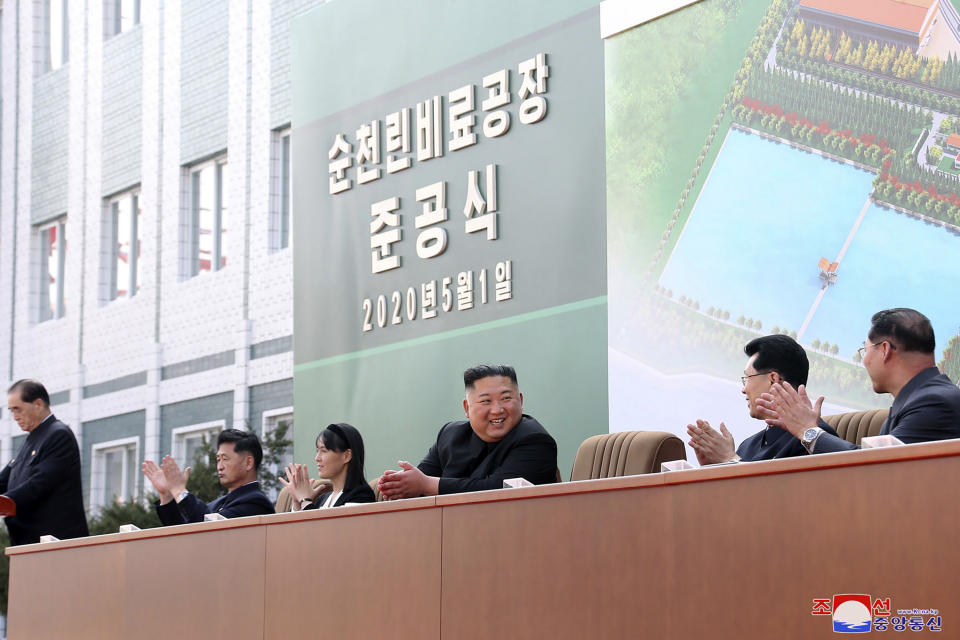 ADDS CITY AND ID OF WOMAN - In this Friday, May 1, 2020, photo provided by the North Korean government, North Korean leader Kim Jong Un, center, claps with his sister Kim Yo Jong, third from left, during a ceremony at a fertilizer factory in Sunchon, South Pyongan province, near Pyongyang, North Korea. Kim made his first public appearance in 20 days as he celebrated the completion of the fertilizer factory, state media said Saturday, May 2, 2020, ending an absence that had triggered global rumors that he may be seriously ill. Independent journalists were not given access to cover the event depicted in this image distributed by the North Korean government. The content of this image is as provided and cannot be independently verified. Korean language watermark on image as provided by source reads: "KCNA" which is the abbreviation for Korean Central News Agency. (Korean Central News Agency/Korea News Service via AP)