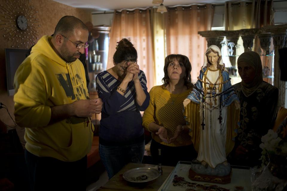 Christians pray in 2014 next to a statue of the Virgin Mary in northern Israel that residents said was weeping oil. <a href="https://newsroom.ap.org/detail/Mideast%20Israel%20Weeping%20Statue/523aed5a7cc742bdbfc4ba56f23a7a2c?Query=statue%20mary%20tear%20weep&mediaType=photo&sortBy=arrivaldatetime:desc&dateRange=Anytime&totalCount=4&currentItemNo=3" rel="nofollow noopener" target="_blank" data-ylk="slk:AP Photo/Ariel Schalit;elm:context_link;itc:0;sec:content-canvas" class="link ">AP Photo/Ariel Schalit</a>