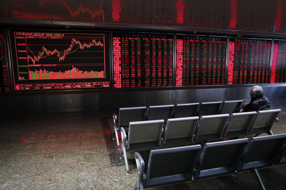 A Chinese investor monitors stock prices at a brokerage house in Beijing, Thursday, Nov. 28, 2019. Asian shares were mostly lower on Thursday after President Donald Trump signed a bill expressing support for human rights in Hong Kong. (AP Photo/Andy Wong)