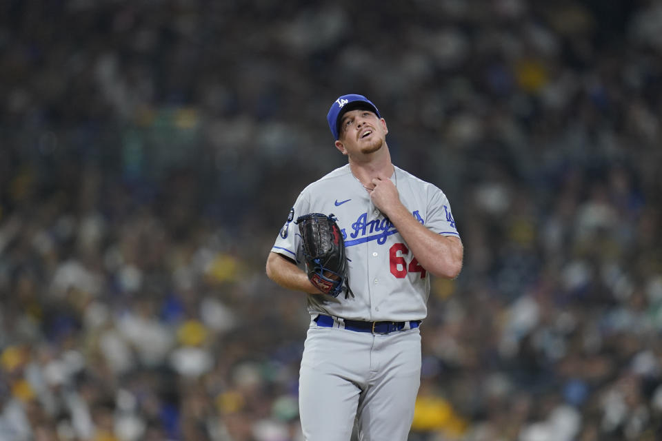 Los Angeles Dodgers relief pitcher Caleb Ferguson adjusts his jersey while working against a San Diego Padres batter during the seventh inning of a baseball game Thursday, Sept. 29, 2022, in San Diego. (AP Photo/Gregory Bull)