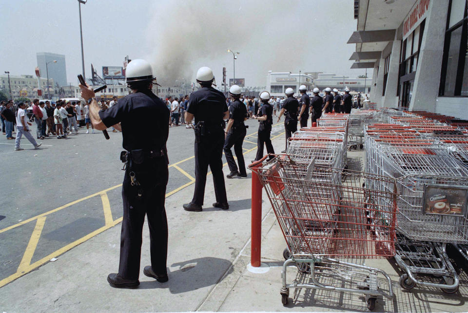 Police officers form line in front of store