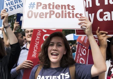 A supporter of the Affordable Care Act celebrates after the Supreme Court up held the law in the 6-3 vote at the Supreme Court in Washington June 25, 2015. REUTERS/Joshua Roberts