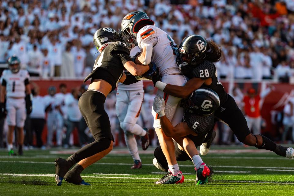 Skyridge High School’s Jack Burke, the ball carrier, is brought down by Corner Canyon High School’s defense during the 6A football state championship at Rice-Eccles Stadium in Salt Lake City on Friday, Nov. 17, 2023. | Megan Nielsen, Deseret News