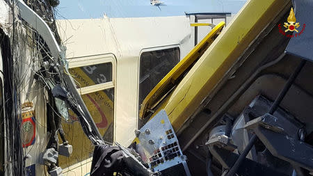 Two passenger trains are seen after a collision in the middle of an olive grove in the southern village of Corato, near Bari, Italy, in this handout picture released by Italian Firefighters July 12, 2016. Italian Firefighters/Handout via Reuters