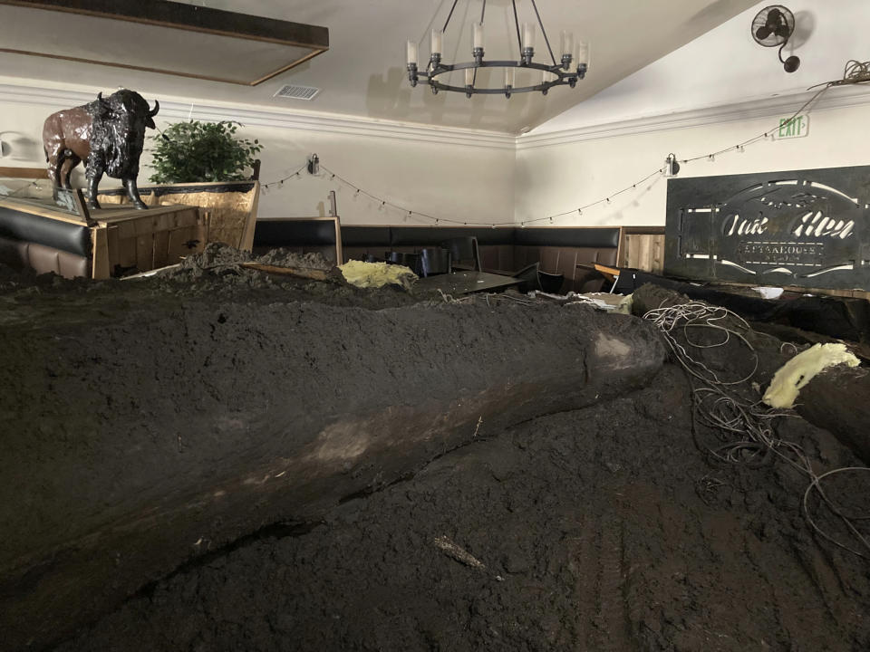 Extensive damage from a slow-moving black river of sludge is seen inside the Oak Glen Steakhouse and Saloon on Wednesday, Sept. 14, 2022, in Oak Glen, Calif. (AP Photo/Amy Taxin)