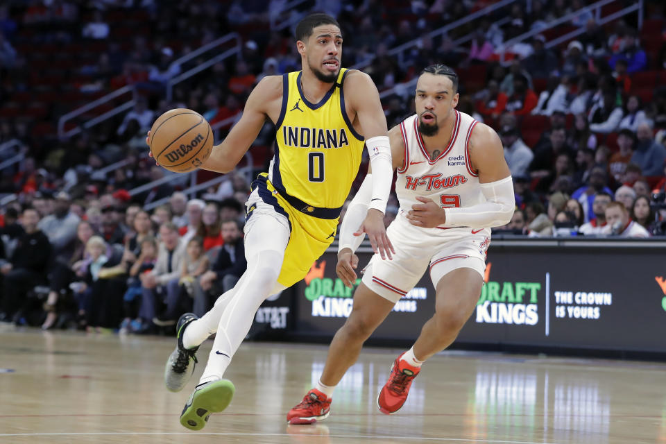 Indiana Pacers guard Tyrese Haliburton (0) drives in front of Houston Rockets forward Dillon Brooks during the first half of an NBA basketball game Tuesday, Dec. 26, 2023, in Houston. (AP Photo/Michael Wyke)