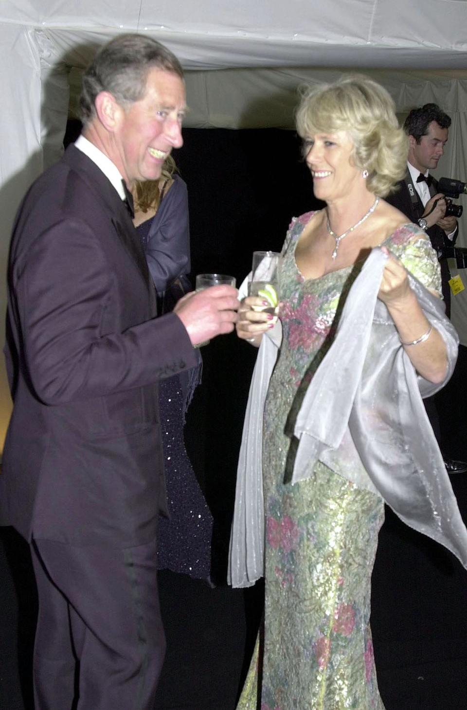 King Charles III and Camilla, Queen Consort laugh at an event in 2001.