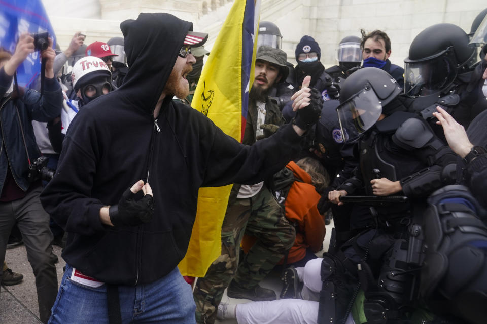 Trump supporters try to break through a police barrier, Wednesday, Jan. 6, 2021, at the Capitol in Washington. As Congress prepares to affirm President-elect Joe Biden's victory, thousands of people have gathered to show their support for President Donald Trump and his claims of election fraud. (AP Photo/John Minchillo)