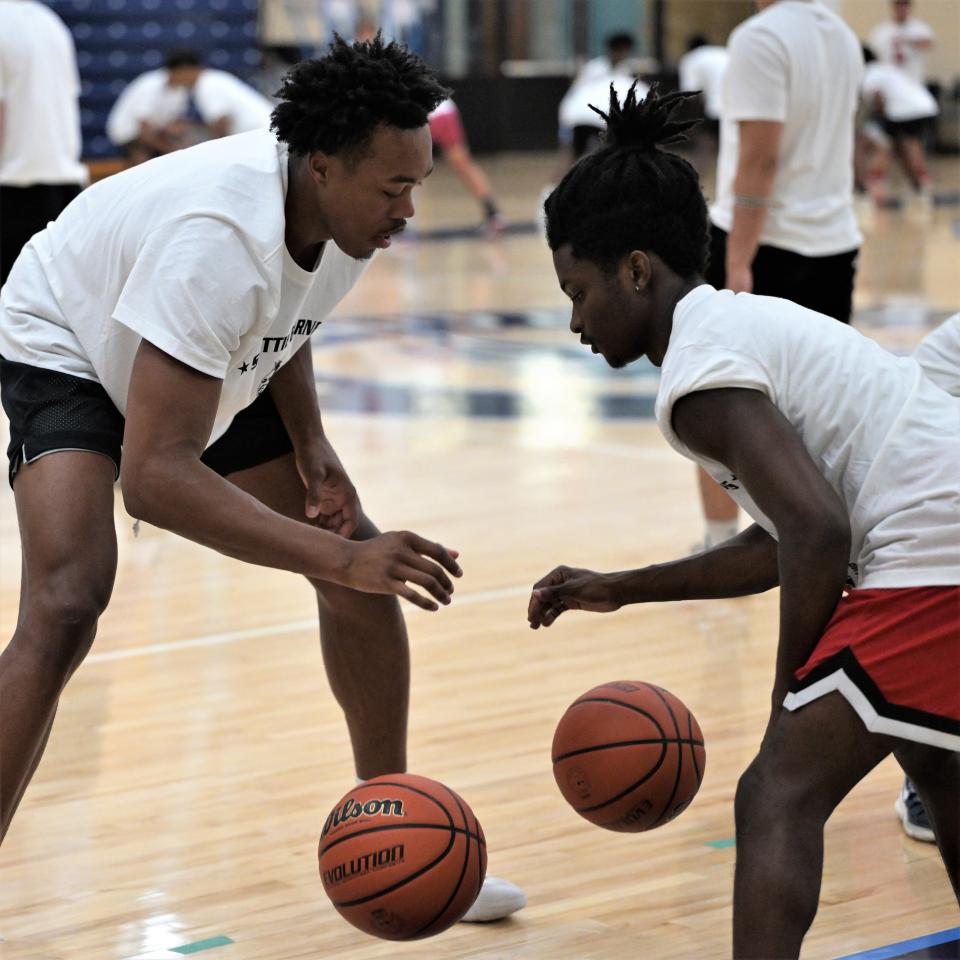 Scottie Barnes works alongside Grandview Prep's Xavian Charles as Barnes' campers practice dribbling drills with partners during  warmups on  July 1.