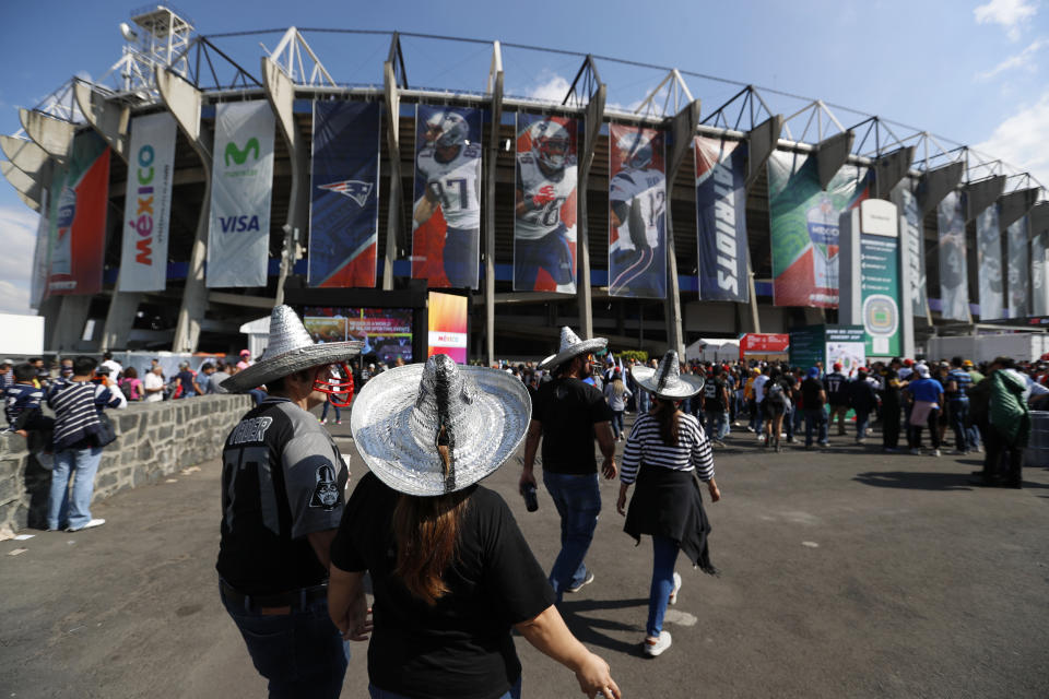 FILE - In this Nov. 19, 2017, file photo, fans arrive at Azteca stadium before an NFL football game between the Oakland Raiders and the New England Patriots in Mexico City. The NFL is moving its five games scheduled for London and Mexico City this season back to U.S. stadiums because of the coronavirus pandemic. All five regular-season games will now be played at the stadiums of the host teams. (AP Photo/Eduardo Verdugo, File)