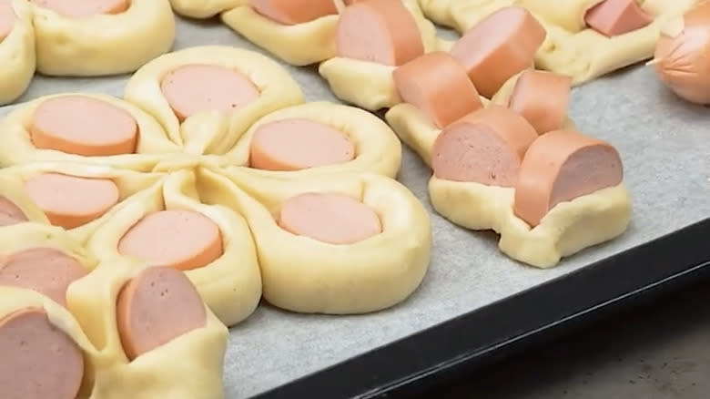 Row of raw pigs in a blanket
