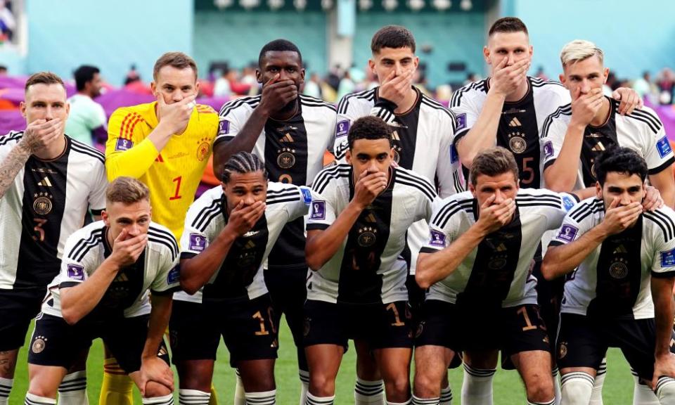 German players cover their mouths as they pose for a team photo ahead of their opening World Cup match.