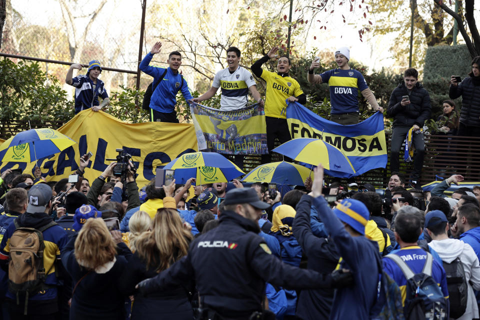 Boca Juniors supporters cheer during a gathering outside the team hotel in Madrid Saturday, Dec. 8, 2018. The Copa Libertadores Final between River Plate and Boca Juniors will be played on Dec. 9 in Madrid, Spain, at Real Madrid's stadium. (AP Photo/Manu Fernandez)