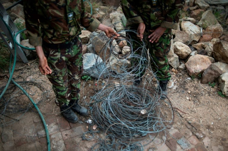 Members of the anti-poaching team "Black Mambas" collect wire traps from a wildlife reserve in Hoedspruit, in the Limpopo province of South Africa