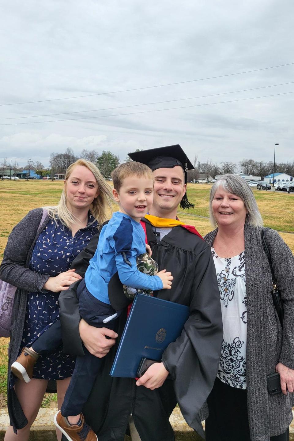 Travis Houser, recent graduate of Middle Tennessee State University's Aeronautical Science master's program, center right, celebrates his graduation with his family in December 2021 on campus. Standing, from left, are his wife, Amber Houser, his son, Nikola Houser, Houser and his mother, Janine McBee.