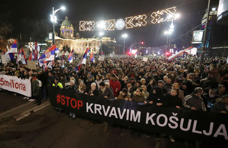 People hold a banner which reads "Stop bloody t-shirts" during an anti-government protest in central Belgrade, Serbia, December 29, 2018. REUTERS/Marko Djurica