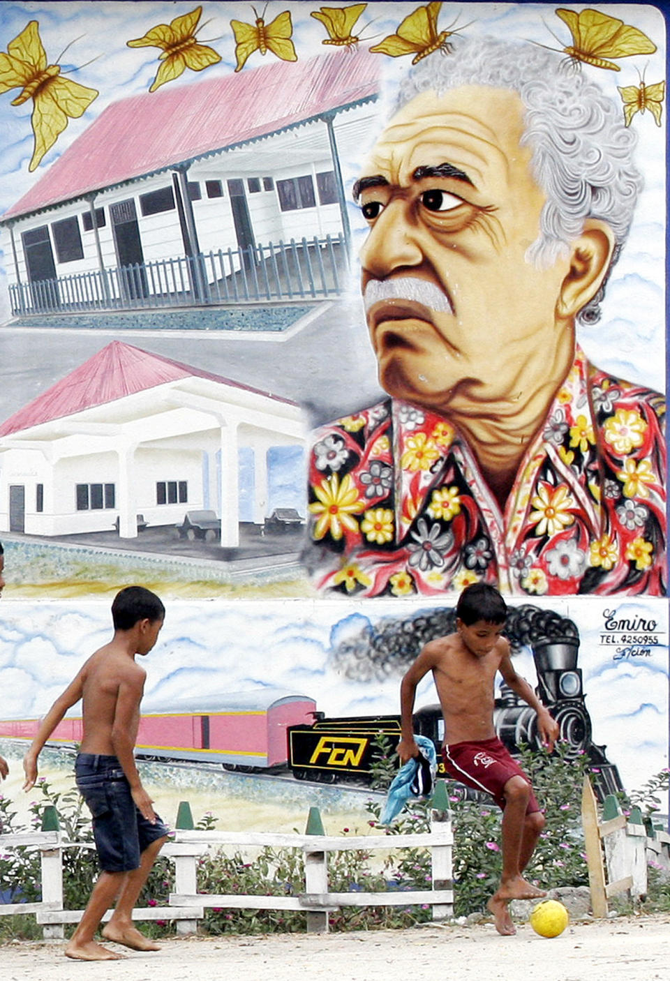 FILE - In this Jan. 4, 2006 file photo, boys play soccer in front a mural of Colombian Nobel laureate Gabriel Garcia Marquez in Aracataca, Colombia, the writer's hometown. Marquez died on Thursday, April 17, 2014 at his home in Mexico City. (AP Photo/Fernando Vergara, File)