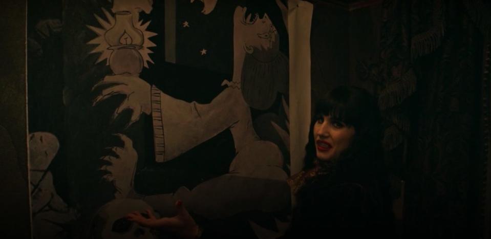 Nadja standing in front of a painting in "What We Do in the Shadows"