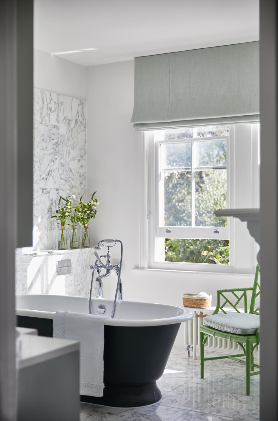 <p> &apos;This room benefits from big, beautiful sash windows which are an instant bonus as the light adds to the sense of scale in what is already a generously proportioned space,&apos; says Natascha Dartnall, interior designer and founder of ND Studios.&#xA0;&apos;Having a free-standing roll top bath is often top of the wish list for many of our clients as they are synonymous with opulence and the promise of relaxation. This tub with its matt exterior finish in black adds contrast and depth to the room; bathrooms with too much white can look a little sterile or impersonal. This is also why the pea green chair works so well here &#x2013; it adds color and texture. Also, a chair is always a good idea in a bathroom for practical reasons such as draping robes over while you bathe.&apos; </p> <p> &apos;Marble will work in any bathroom &#x2013; it always looks, clean, fresh and speaks to understated extravagance. People often&#xA0;ask about bathroom storage as it can be difficult to navigate. Generally, rustic baskets are a godsend and prevent lotions and potions spreading untidily across every available space.&apos; </p>