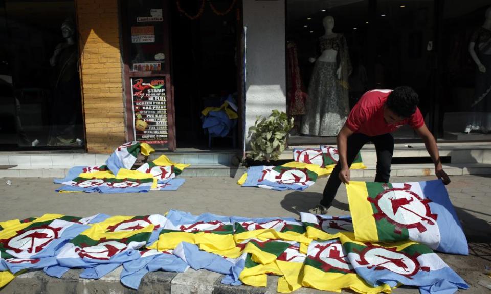 A man dries screen-printed flags of the Rastriya Prajatantra party in Kathmandu