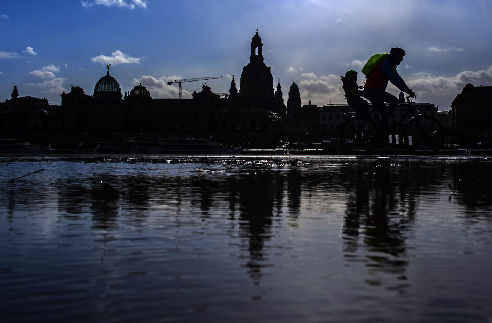 The sun shines behind Dresden's Old Town skyline with the Frauenkirche cathedral (Church of Our Lady), reflected in a puddle, in Dresden, Germany Tuesday, Feb. 11, 2020 two days before the 75th anniversary of the Allied bombing of Dresden during WWII. British and U.S. bombers on Feb. 13-14, 1945 destroyed Dresden's centuries-old baroque city center. (AP Photo/Jens Meyer)