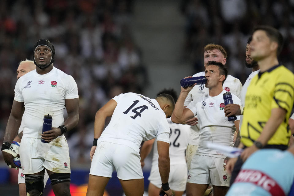 England's Maro Itoje, left, with his teammates watch a try attempt review on an electronic screen during the Rugby World Cup Pool D match between England and Samoa at the Stade Pierre Mauroy in Villeneuve-d'Ascq, outside Lille, France, Saturday, Oct. 7, 2023. (AP Photo/Themba Hadebe)