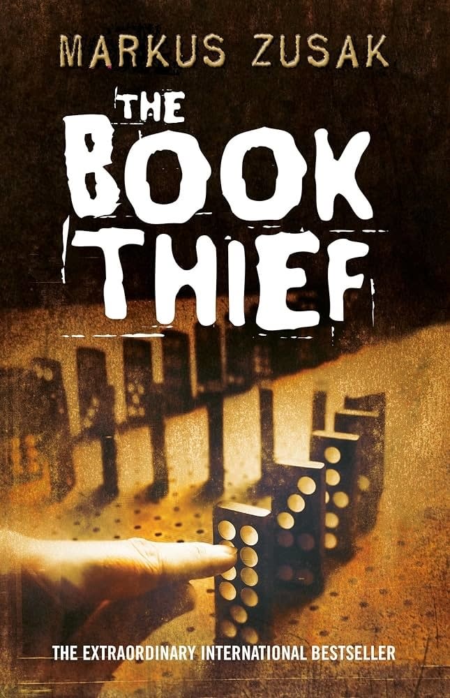 Cover of "The Book Thief" by Markus Zusak, featuring dominoes and a city silhouette