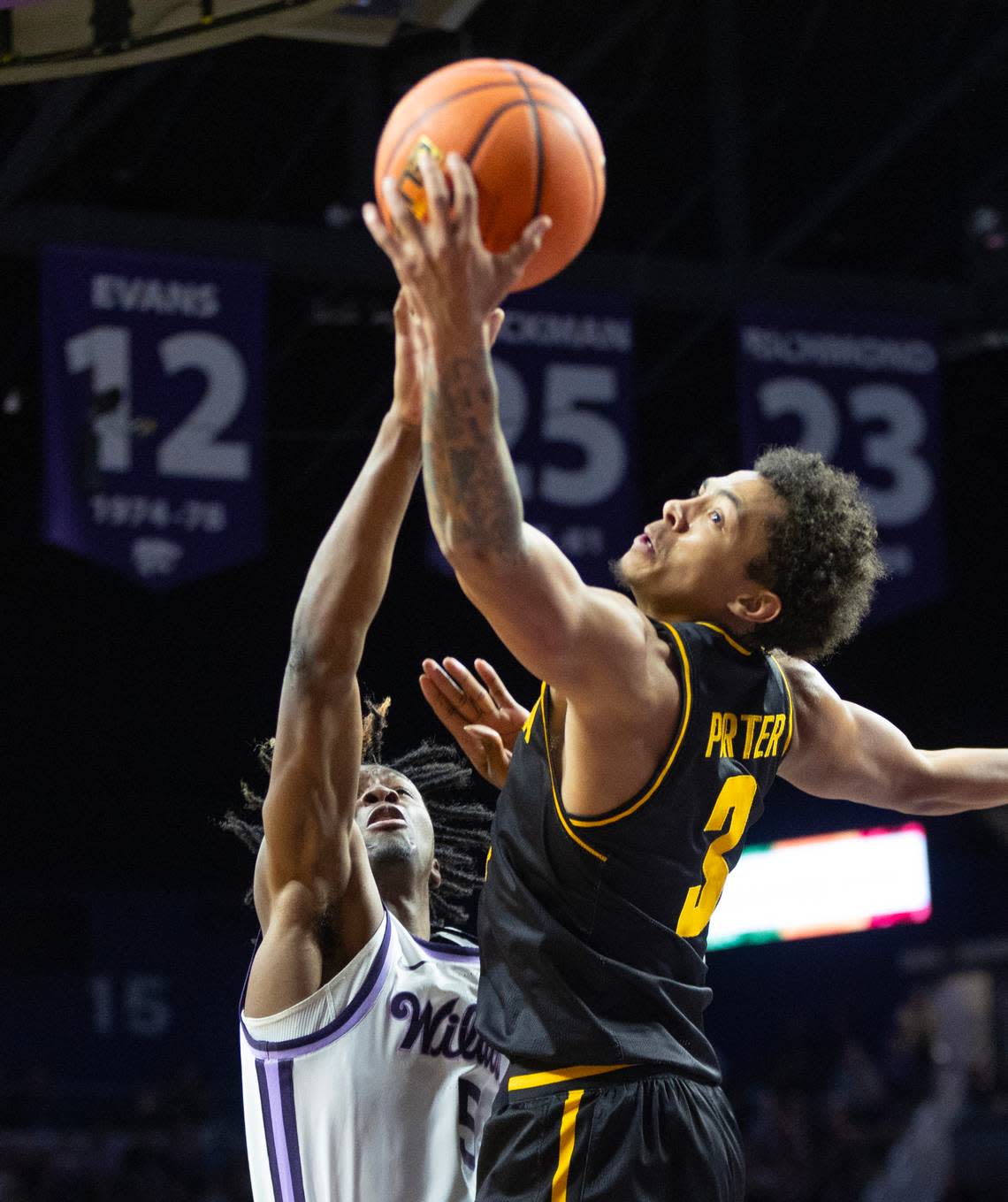 Wichita State’s Craig Porter Jr., fights for a rebound against Kansas State’s Cam Carter during the second half on Saturday night in Manhattan.