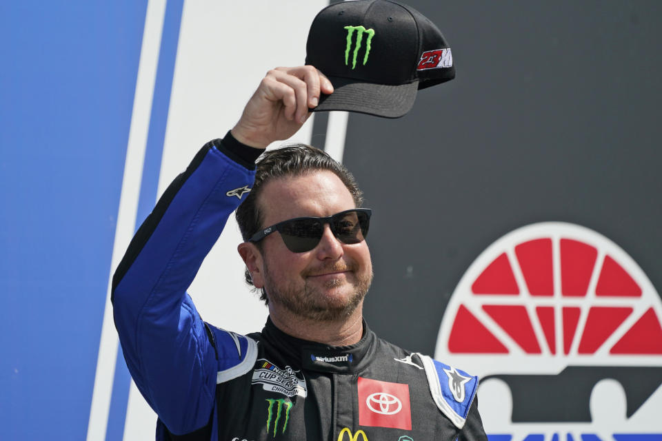 FILE - NASCAR Cup Series driver Kurt Busch tips his cap prior to the NASCAR Cup Series auto race at the New Hampshire Motor Speedway, Sunday, July 17, 2022, in Loudon, N.H. Busch announced Saturday, Oct. 15 he will miss the rest of this season with a concussion and will not compete full-time in 2023. The 44-year-old made his announcement at Las Vegas Motor Speedway, his home track and where he launched his career on the bullring as a child. He choked up when he said doctors told him “it is best for me to ‘shut it down.'” (AP Photo/Charles Krupa, File)