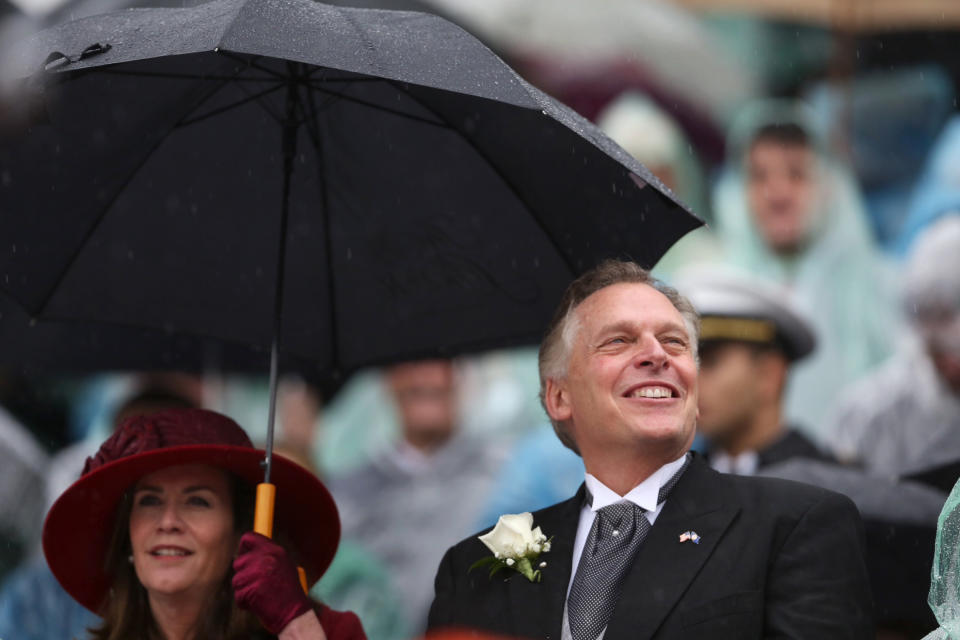 Terry McAuliffe and his wife Dorothy use an umbrella as McAuliffe is sworn in as Virginia's 72nd governor on Saturday, Jan. 11, 2014 at the state Capitol in Richmond, Va. (AP Photo/The Virginian-Pilot, Steve Earley)