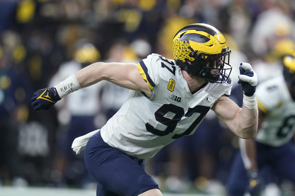 Michigan defensive end Aidan Hutchinson (97) rushes up field during the second half of the Big Ten championship NCAA college football game against Iowa, Saturday, Dec. 4, 2021, in Indianapolis. (AP Photo/Darron Cummings)