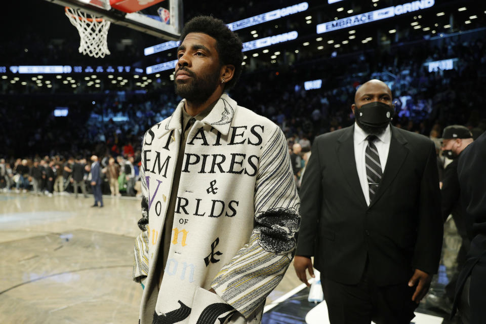 NEW YORK, NEW YORK - MARCH 13: Kyrie Irving #11 of the Brooklyn Nets attends the first half against the New York Knicks at Barclays Center on March 13, 2022 in the Brooklyn borough of New York City. NOTE TO USER: User expressly acknowledges and agrees that, by downloading and or using this photograph, User is consenting to the terms and conditions of the Getty Images License Agreement. (Photo by Sarah Stier/Getty Images)