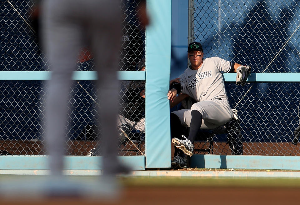 LOS ANGELES, CALIFORNIA - JUNE 03: Aaron Judge #99 of the New York Yankees crashes through the outfield fence as he makes a catch for an out of JD Martinez #28 of the Los Angeles Dodgers during the eighth inning at Dodger Stadium on June 03 , 2023 in Los Angeles, California.  (Photo by Harry How/Getty Images)