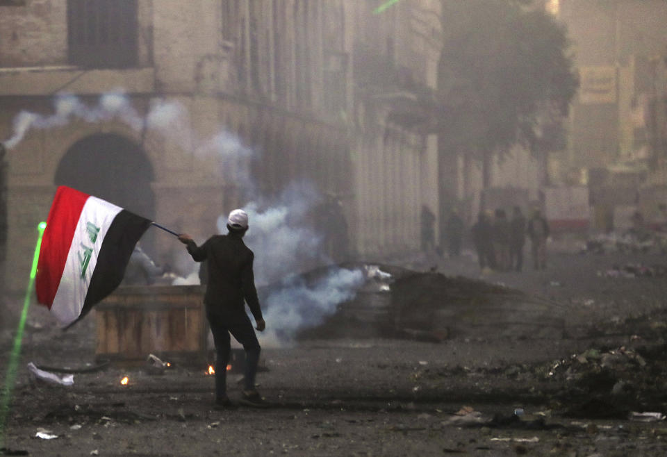 Riot police fire tear gas during clashes with anti-government demonstrators in Baghdad, Iraq, Saturday, Nov. 23, 2019. (AP Photo/Hadi Mizban)