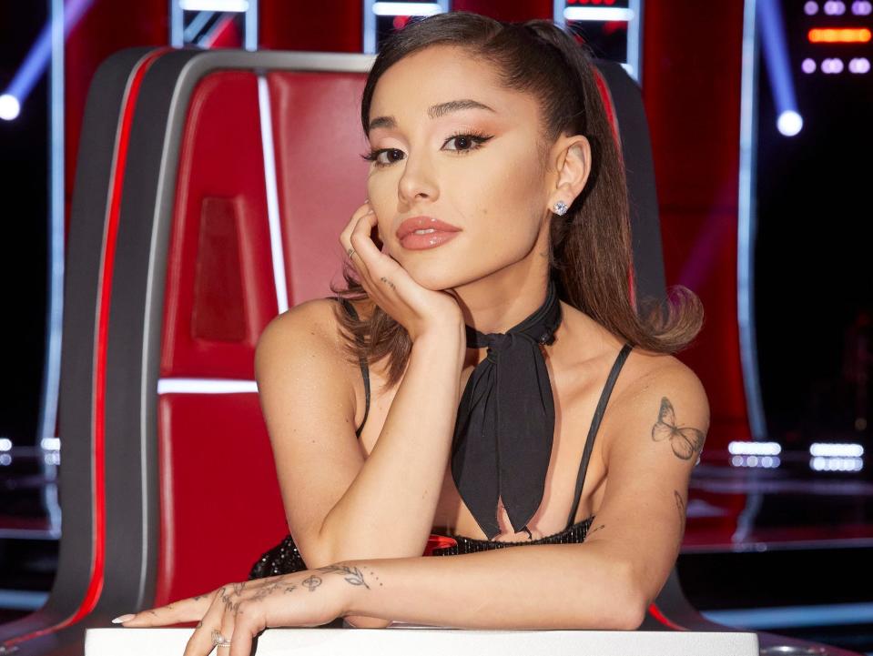 ariana grande posing for a photo in a coach chair on the voice