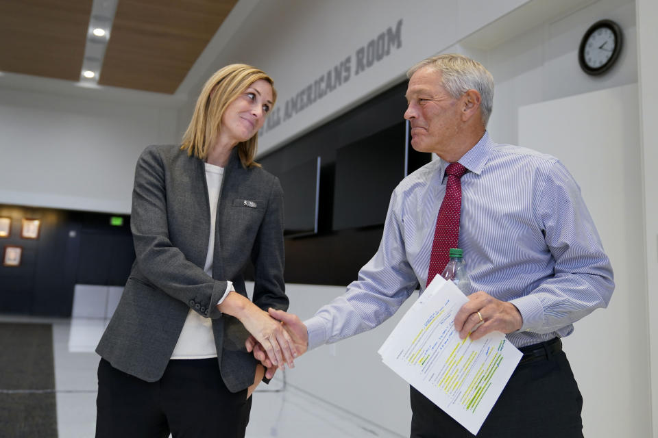 Iowa interim athletic director Beth Goetz, left, greets Iowa head coach Kirk Ferentz after a news conference, Tuesday, Oct. 31, 2023, in Iowa City, Iowa. Goetz announced on Monday that Ferentz's son, Brian, would not return as offensive coordinator next year. (AP Photo/Charlie Neibergall)