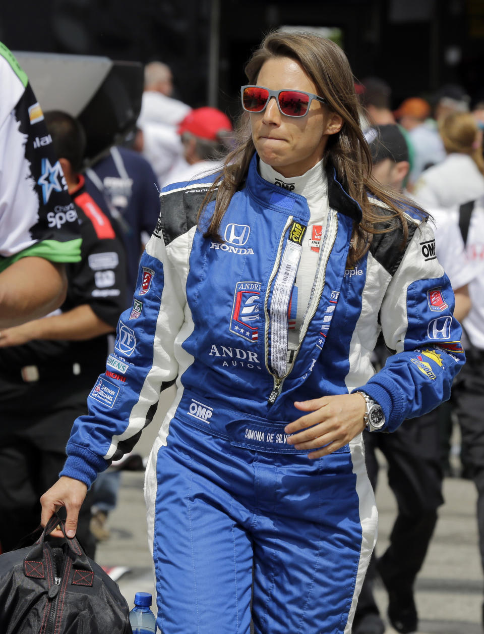 FILE - In this Friday, March 27, 2015, file photo, Simona de Silvestro, of Switzerland, walks to her car before practice for the IndyCar Firestone Grand Prix of St. Petersburg auto race in St. Petersburg, Fla. Beth Paretta and Simona de Silvestro will be teaming up to put another woman on the Indianapolis 500 starting grid this May. On Tuesday, Jan. 19, 2021, Paretta Autosport and IndyCar officials announced they would work together to put a predominantly women-run team in the series' biggest race as part of an outreach to create more diversity in motorsports. (AP Photo/Chris O'Meara, File)