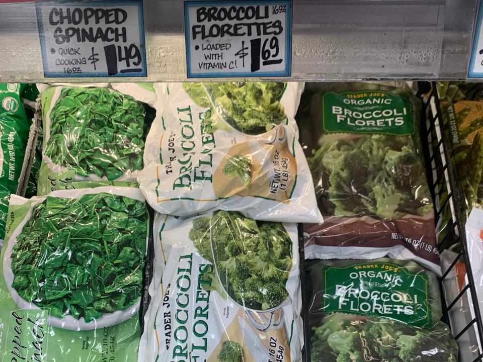 bags of broccoli florets in the freezer aisle of trader joes